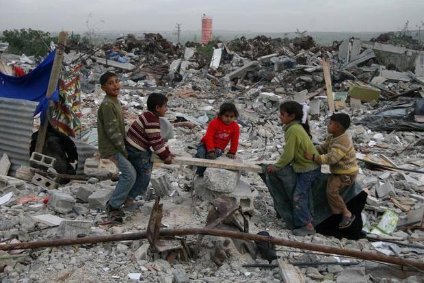 Palestinian children play in rubble