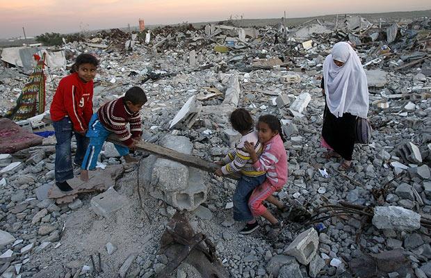Palestinian children play in rubble